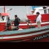 Zoom Chilean fishermen on a boat